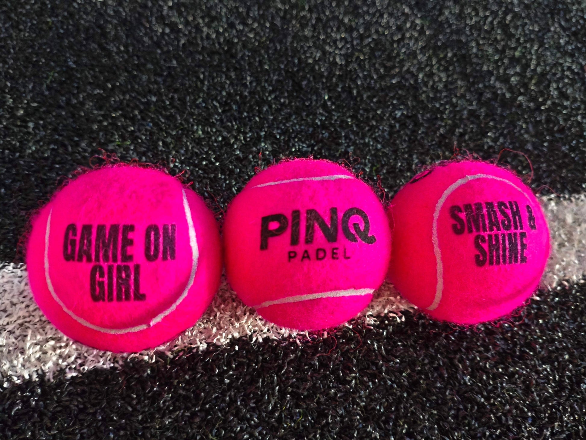 Three Pinq padel balls, with text